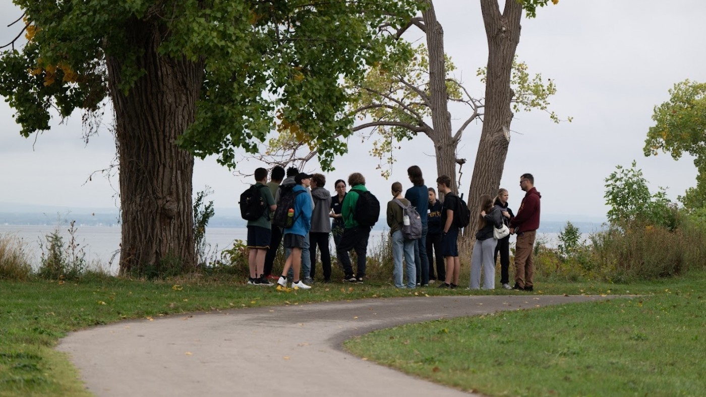 A group of students gather beside Lake Erie.