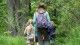 People walking down a grassy trail