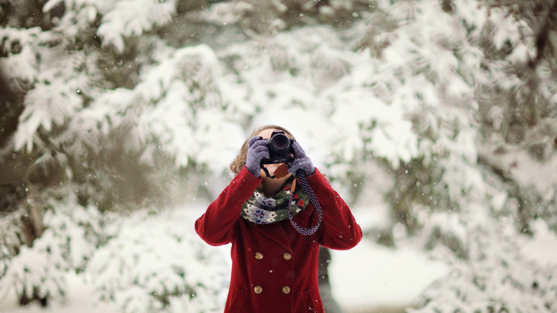 Woman Holding Dslr Camera in front of tree