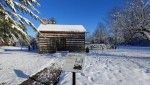 Cabin in the Glen Elgin village, covered in snow.