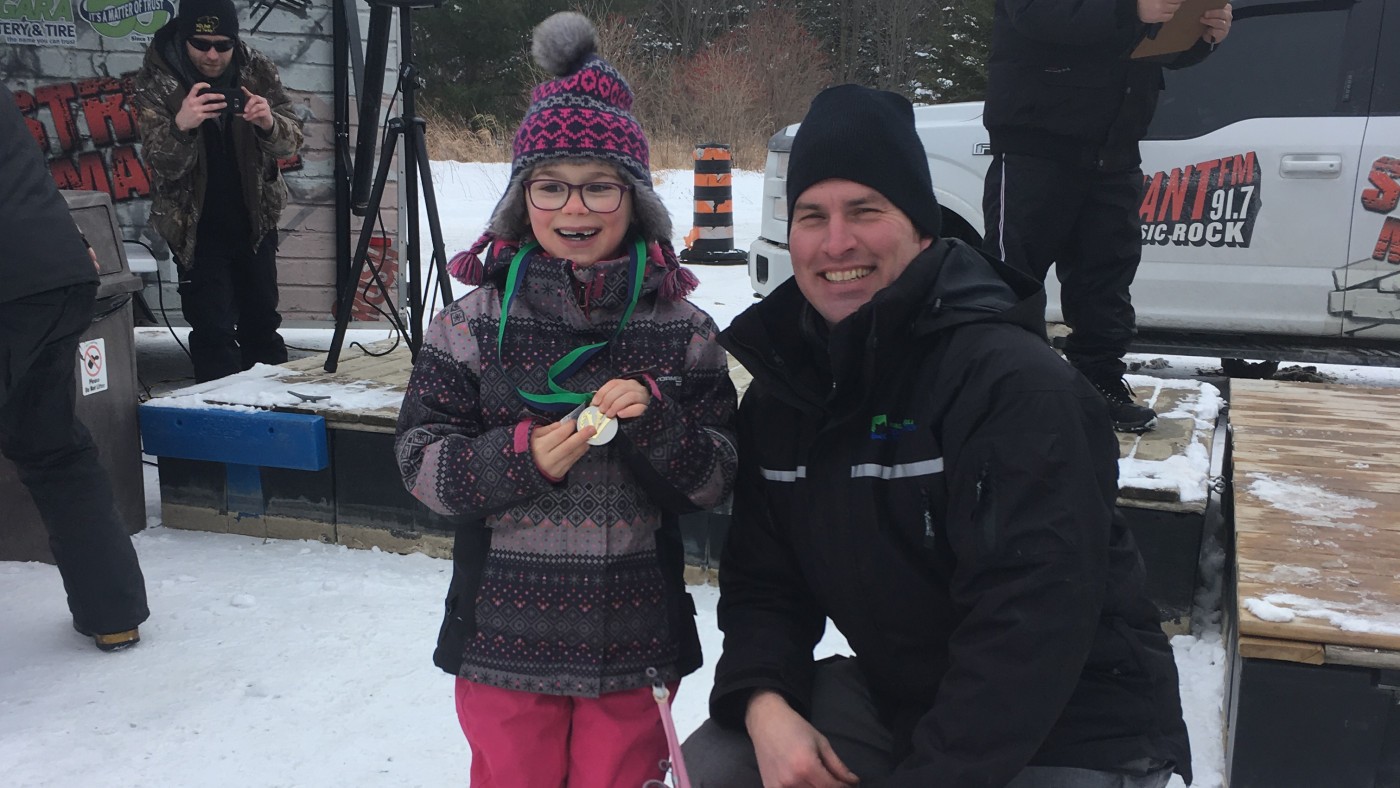 Binbrook Superintendent poses with little girl, winner of ice derby prize