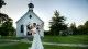 Bride and groom kissing outside chapel