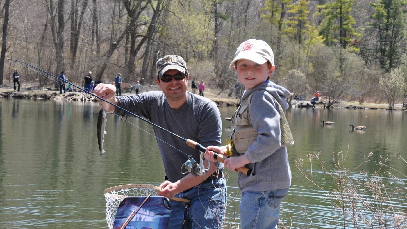 Father and son show fish just caught at St. Johns pond 