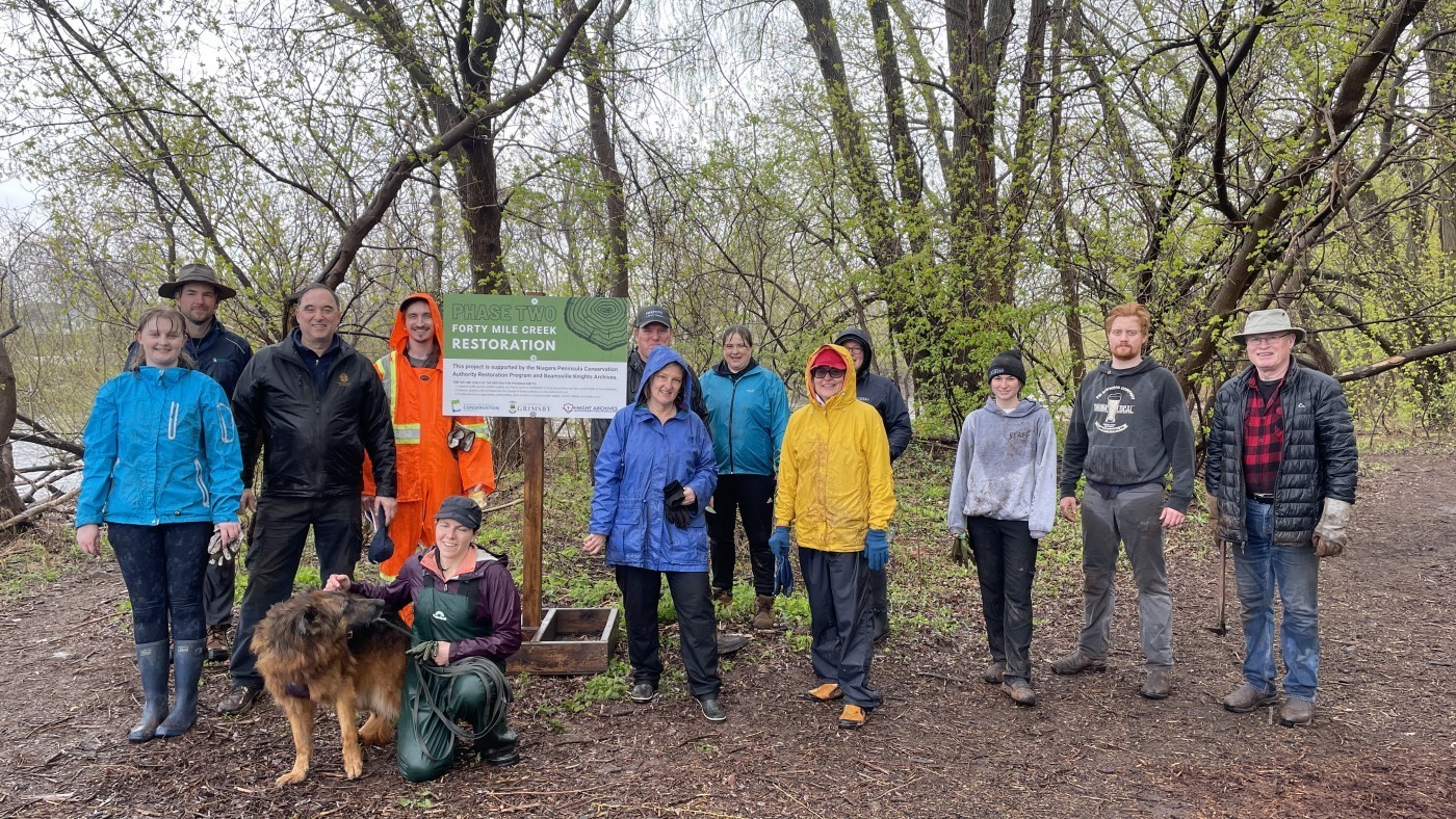 Group of volunteers and partners gather at 40 Mile Creek in Grimsby 