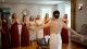 Bride showing her bridesmaids her dress
