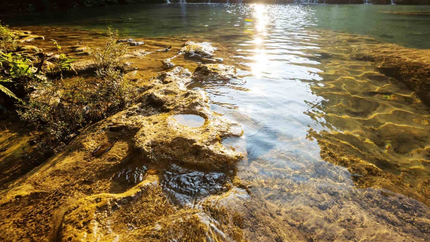 Brown rocks under a river 