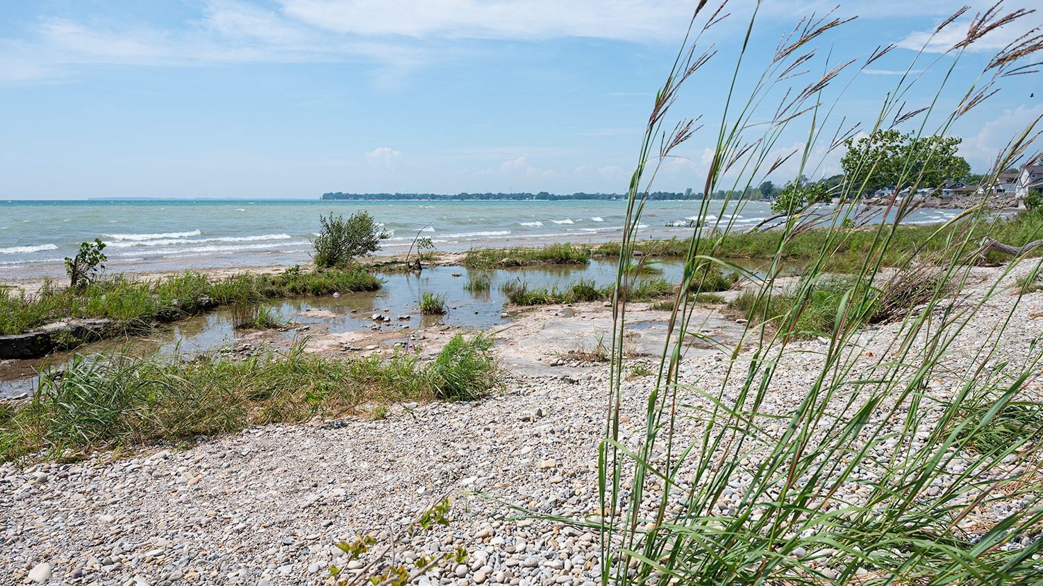 river rock beach by lake and wind